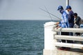 Thai angler or fisherman use fishing-rod fishing fish in the sea Royalty Free Stock Photo