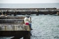 Thai angler or fisherman use fishing-rod fishing fish in the sea