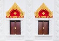 Thai art style of window in public temple with cha-da on top of Royalty Free Stock Photo