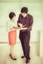 Thai (Asian) boss is ordering a task for his cute secretary in t