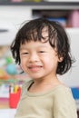 Thai asian boy smile with green shirt on blur background