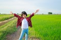 Thai Asian kid girl, aged 4 to 6 years old, looks cute, wearing a plaid shirt, jeans, fashion style. playing outdoors It is a Royalty Free Stock Photo
