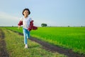 Thai Asian kid girl, aged 4 to 6 years old, looks cute, wearing a plaid shirt, jeans, fashion style. playing outdoors It is a Royalty Free Stock Photo