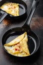 Thai  Asian omelette, fresh red chilli, brown and white crabmeat, lemon, Cheddar cheese, eggs, on frying iron pan, on old dark Royalty Free Stock Photo