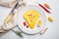 Thai Asian omelette, fresh red chilli, brown and white crabmeat, lemon, Cheddar cheese, eggs, on plate, on white background, top