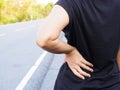 Thai asian woman with lumbar pain, backache and massage on waist to pain relief Royalty Free Stock Photo