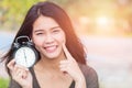 Thai Asian women show and point her face aside with clock