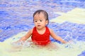 Thai baby girl hit the water Royalty Free Stock Photo