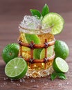 Thai bamboo beer glass with lime garnish, rustic wood table and condensation Royalty Free Stock Photo