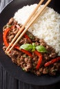 Thai Basil Beef, or Pad Gra Prow with rice side dish close-up. Vertical top view