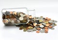 Thai bath coins spilling out of a glass jar. Royalty Free Stock Photo