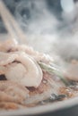 Thai BBQ Grill Pork on a stove hot pan buffet with smoke floating over the stove Royalty Free Stock Photo