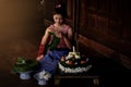Thai beautiful women wearing traditional dresses make Krathong f