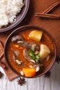 Thai beef massaman curry and rice side dish closeup. vertical to Royalty Free Stock Photo