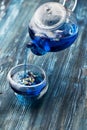 Thai blue tea Anchan in a glass teapot and a cup Royalty Free Stock Photo