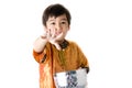 Thai boy splashing water by using hand from bowl Royalty Free Stock Photo