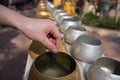 Thai Buddhist donate coin in monk's bowl