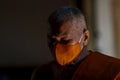 A Thai Buddhist monk wearing a facemask