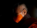 A Thai Buddhist monk wearing a facemask