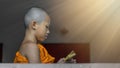 Thai buddhist novice in orange robe Royalty Free Stock Photo