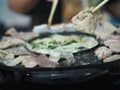 Thai buffet with pork, shrimp and other meats grilled fried cooked on brass barbecue pan food cha-bu