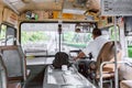 Thai bus driver in control seat in back view. Bangkok Thailand Public mass transportation in summer vibe before Covid-19 epidemic