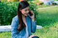 Asian business woman in office uniform Talking on the cell phone with the customer sitting on the table Royalty Free Stock Photo