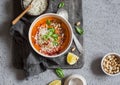 Thai carrot sweet potato soup with rice on the dark table, top view.