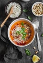 Thai carrot sweet potato soup with rice on the dark table, top view.