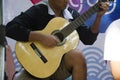 Thai child people playing acoustic guitar for show travellers pe