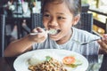 Thai children eating in restaurant