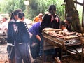 Thai children karen ethnic group and tribe merchant cooking sweet potato roasted grilled on stove for sale thai people travelers Royalty Free Stock Photo