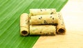 Thai coconut cracker roll on banana leaf.