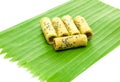 Thai coconut cracker roll on banana leaf.