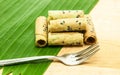 Thai coconut cracker roll on banana leaf.