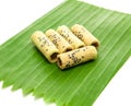 Thai coconut cracker roll on banana leaf.