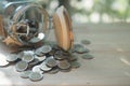 Thai coins in and outside the glass jar, Thai Baht currency Royalty Free Stock Photo