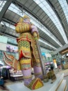 THAI colourful vintage giant STATUE standing in front of gate in SUVARNABHUMI airport in BANGKOK