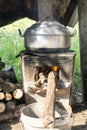 Thai cooking style, steam pot on vintage local fire-stove in kitchen of old wooden house Royalty Free Stock Photo