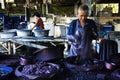 Thai craftsmanship technician or professional artist working batik ikat and tie dye with indigo color or mauhom natural colour in