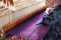 Thai craftsmanship technician professional use antique local wooden machine loom weaving hand woven cotton fabric for show Royalty Free Stock Photo