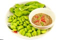 Thai cuisine Bitter Beans and Spicy Chili Paste Nam Prik serve with vegetables isolated on white background