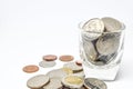 Thai currency coins placed in a clear glass on a white background, Saving concept for future, Thai coins