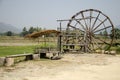 Thai Dam Cultural Village and big wooden turbine baler water wheel Royalty Free Stock Photo