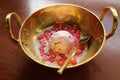 Thai dessert called Tub Tim Grob or Mock Pomegranate in coconut milk served with ice cream in gold brass bowl Royalty Free Stock Photo