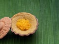 Thai dessert, egg custard with sweet sticky rice topped with golden threads, on banana leaf background Royalty Free Stock Photo