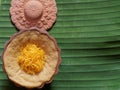 Thai dessert, egg custard with sweet sticky rice topped with golden threads, on banana leaf background Royalty Free Stock Photo