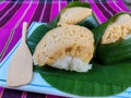 Thai dessert wrapped in green bananas. Sticky rice with custard