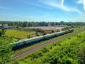 Thai diesel engine locomotive drives on the railway and pull the railroad track maintenance train and passenger bogeys Royalty Free Stock Photo