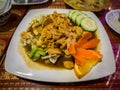 Thai dish ginger chicken on white plate with carrot flower